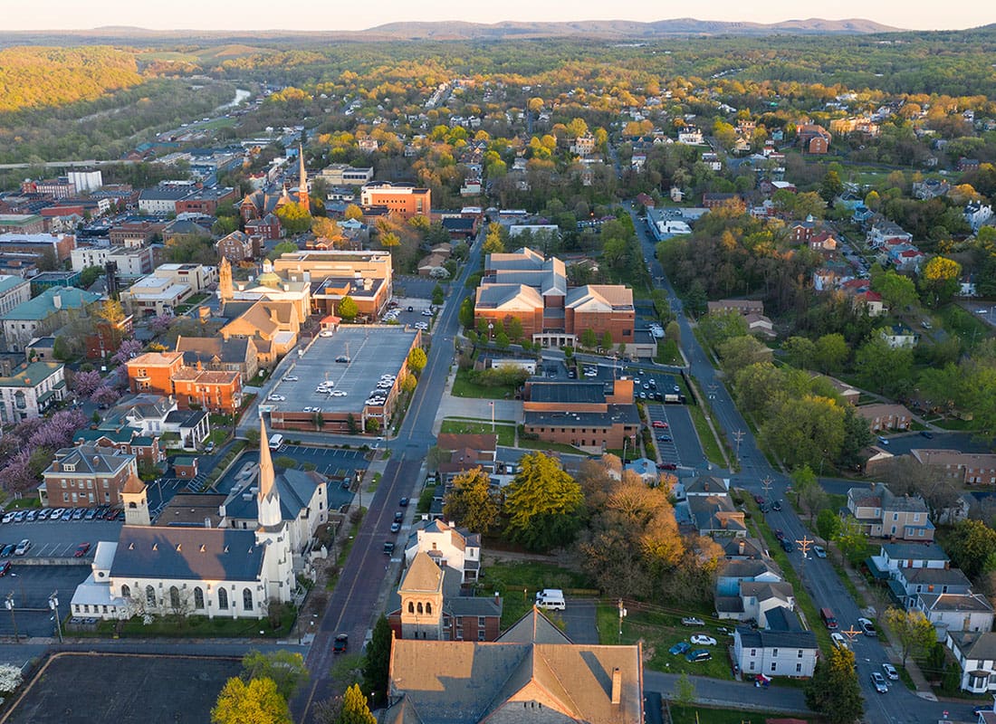 About Our Agency - Aerial View of Historic Downtown Lynchburg Virginia Buildings and Homes on a Sunny Day